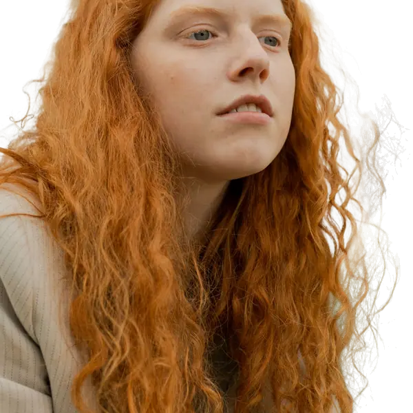 Woman with long red curly hair with the background removed